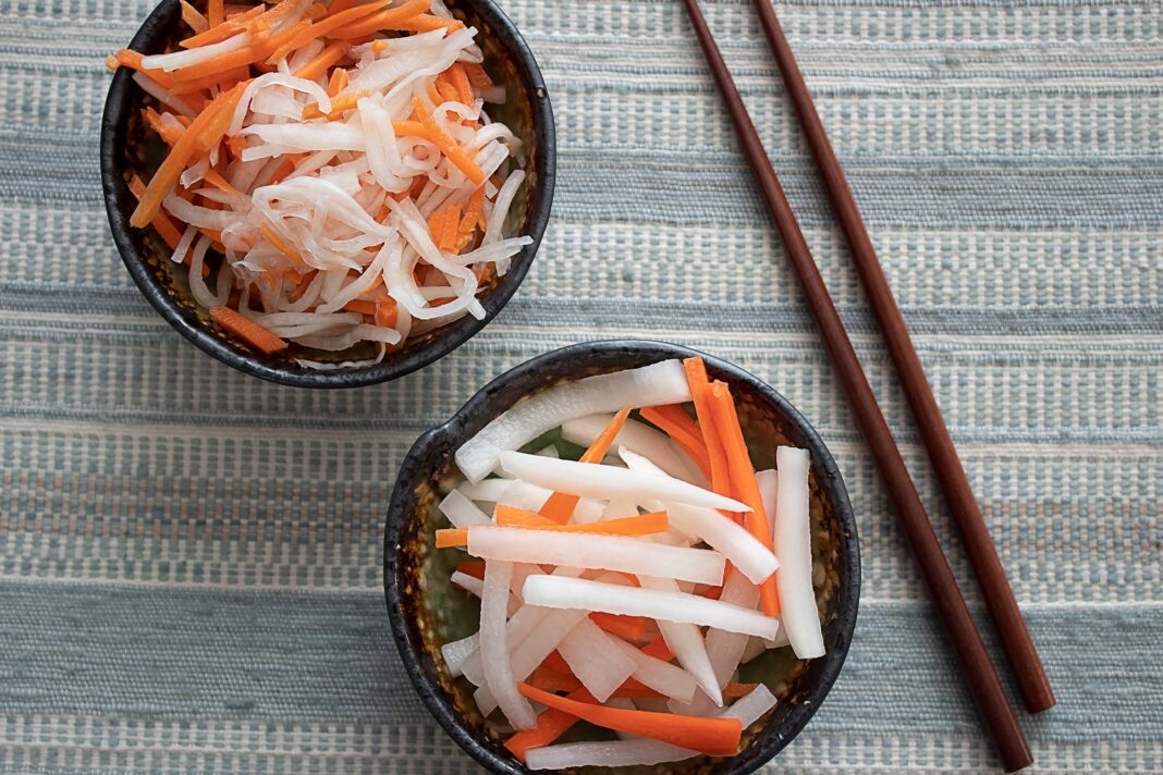 two bowls of pickled daikon radish and carrots