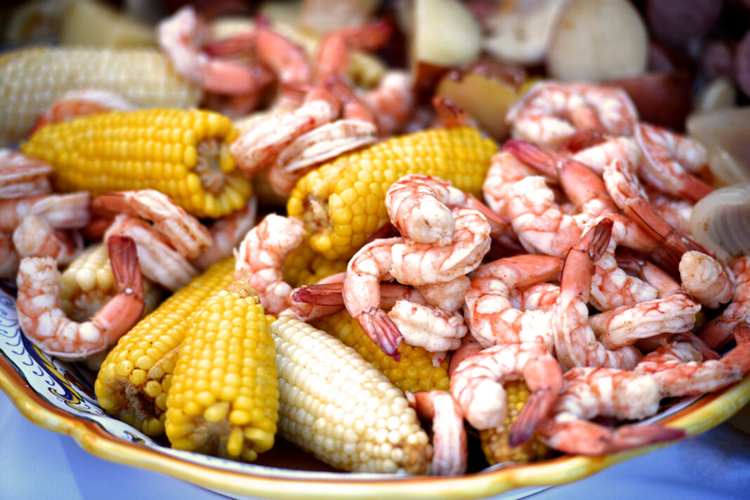 a low country shrimp boil served on a light blue tablecloth