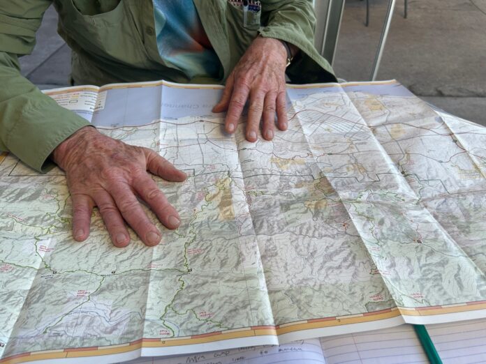 dan mccaslin points at a trail map