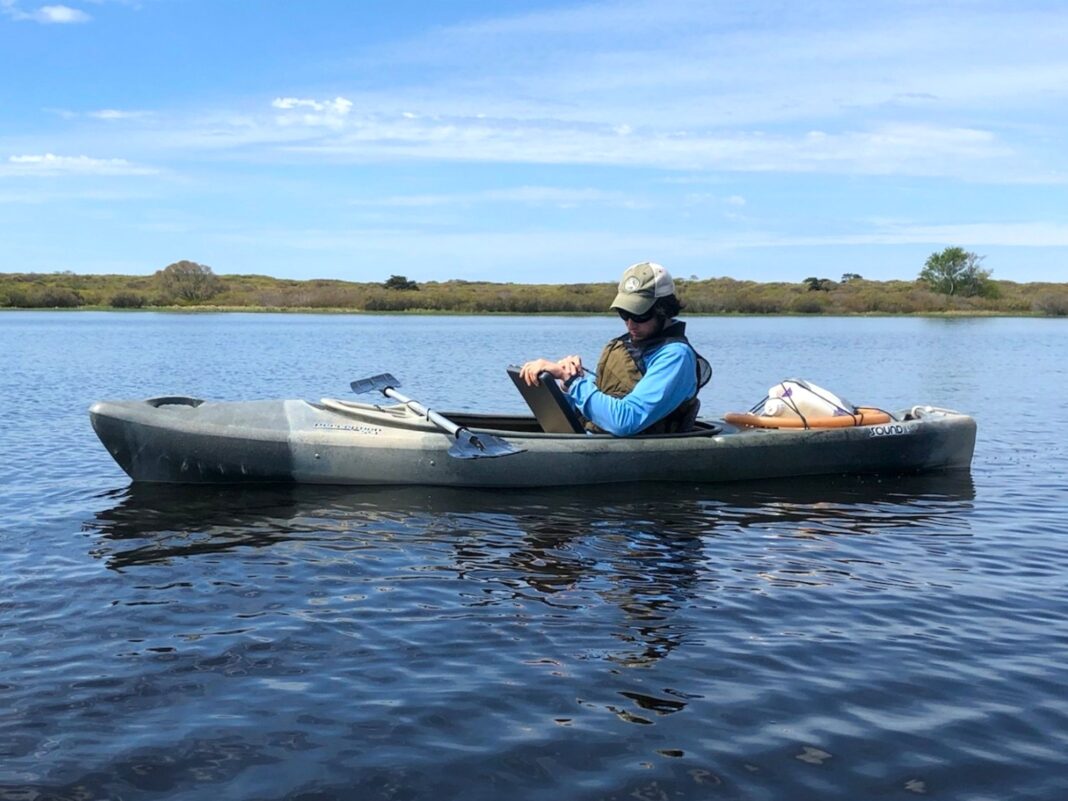 rj turcotte sits in a canoe on the water