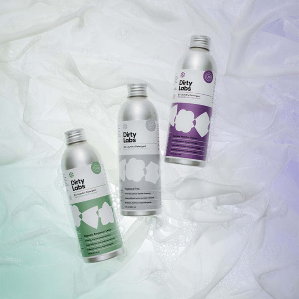three aluminum jars of dirty labs laundry detergent