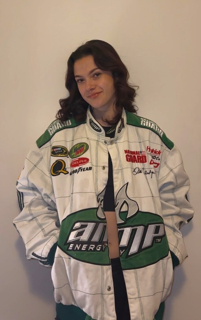 char kelly weraing a green and white racing jacket
