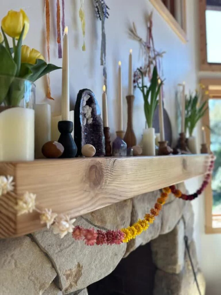 a flower garland hangs from a mantel