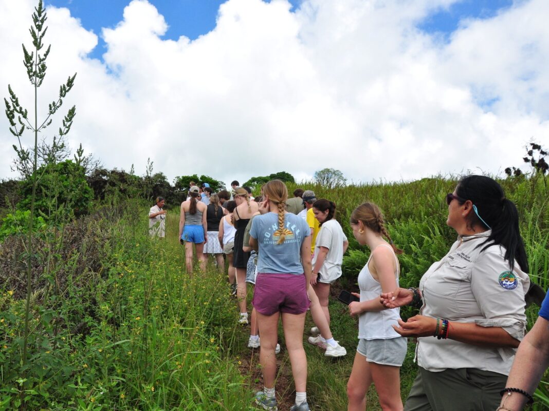 nantucket students walk in a line as they take a tour of the galapagos