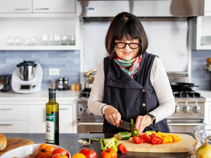 Vicki Risken cutting veggie sin her home