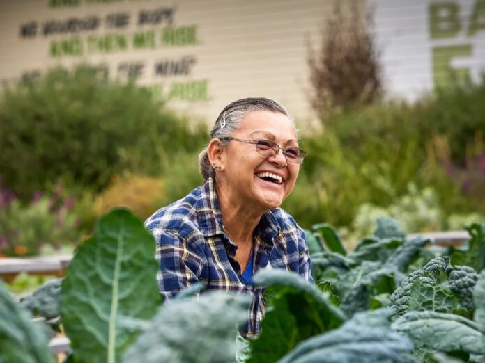 a woman standing in a field of leaves