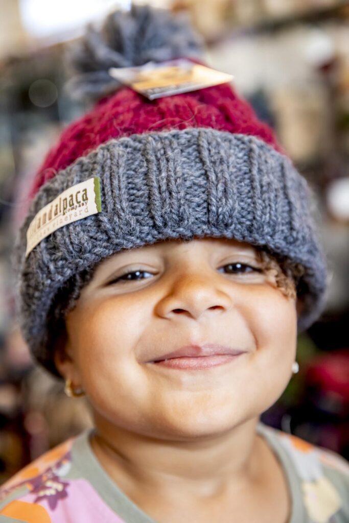 a young girl wearing a fleece hat