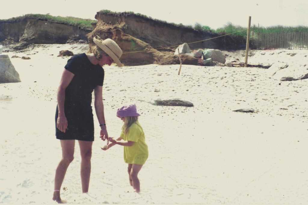 a young bella bennett giving her mom shells she found on the beach