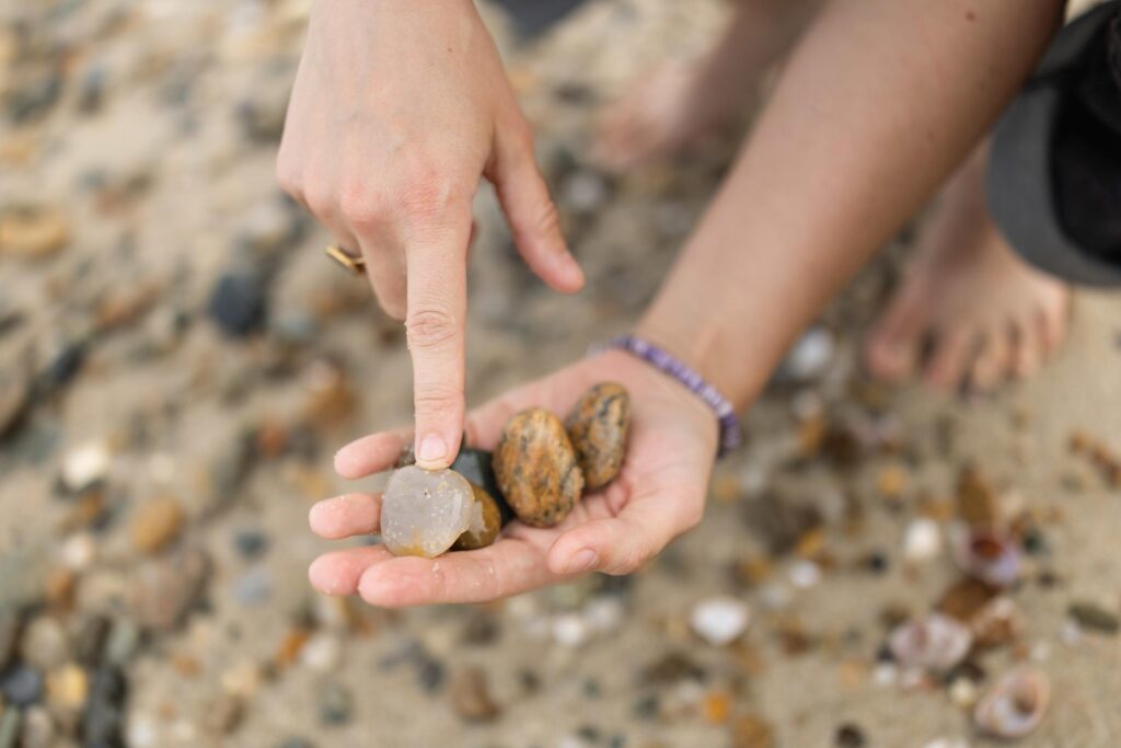 bella holds beach rocks in her hand