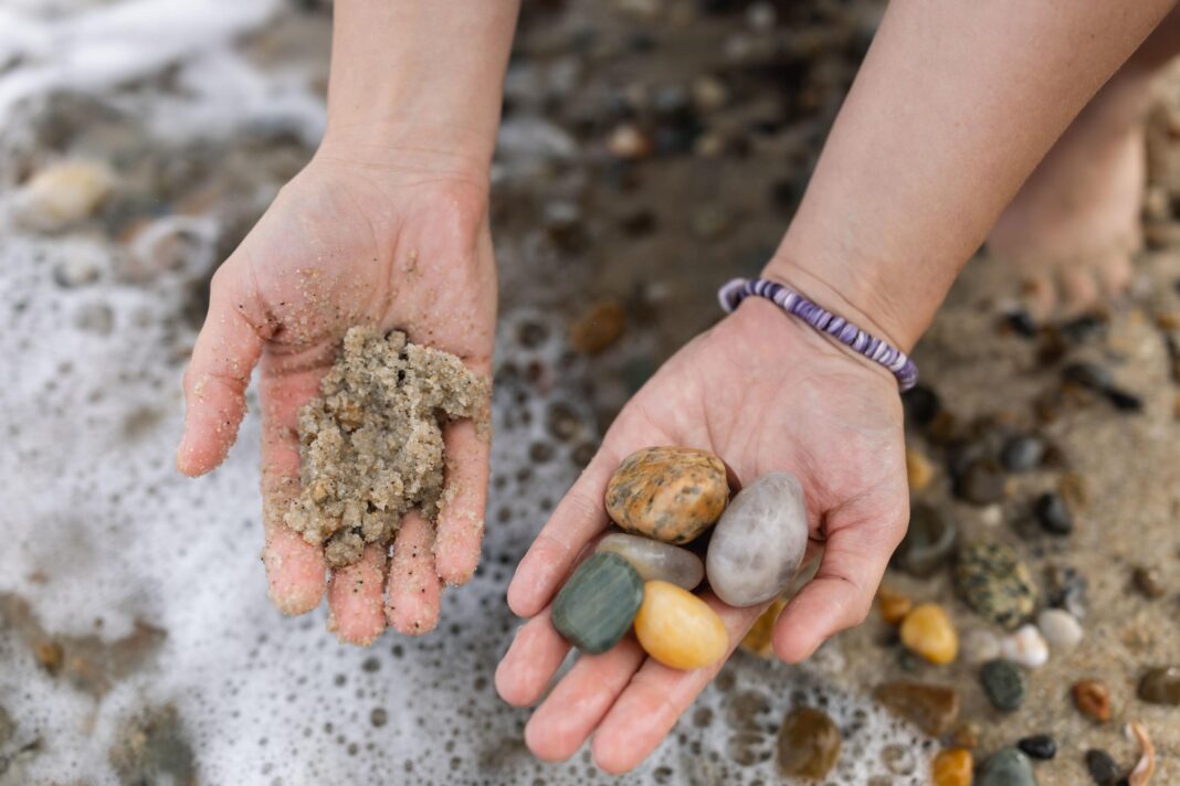 hand holding shells and rocks