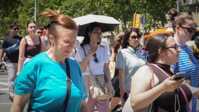 pedestrians walking outside in the heat