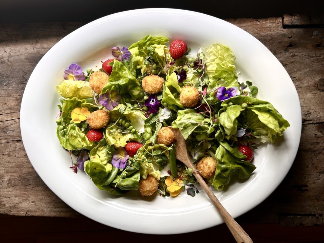 Summer Salad With Pansies, Peas, Strawberries, and Fried Goat Cheese in a Honey Vinaigrette