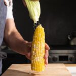 peeling the husk off of corn that's been microwaved