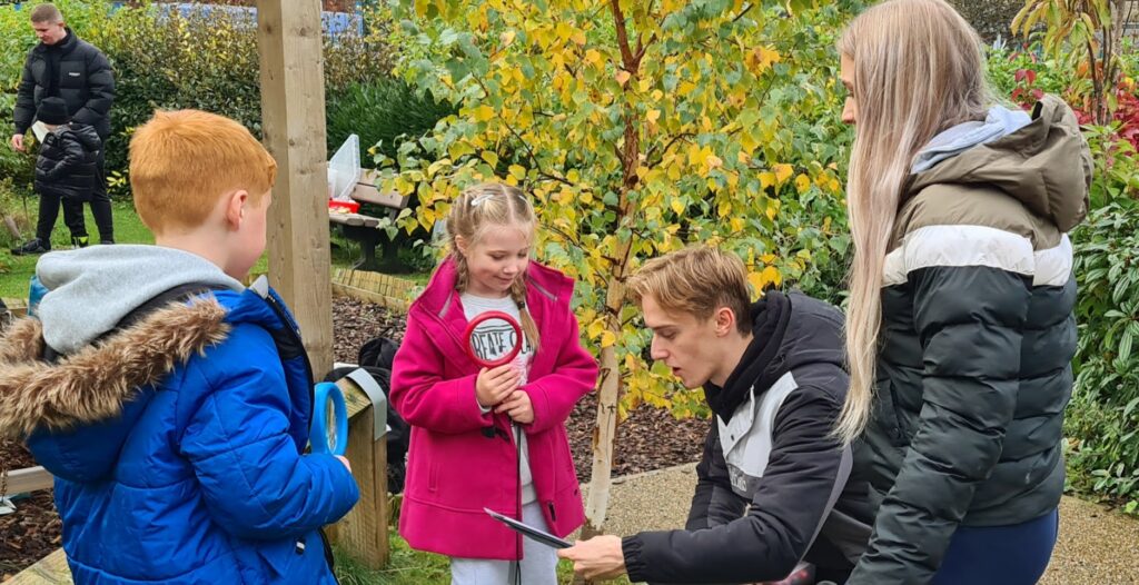 students learning outdoors at forest school