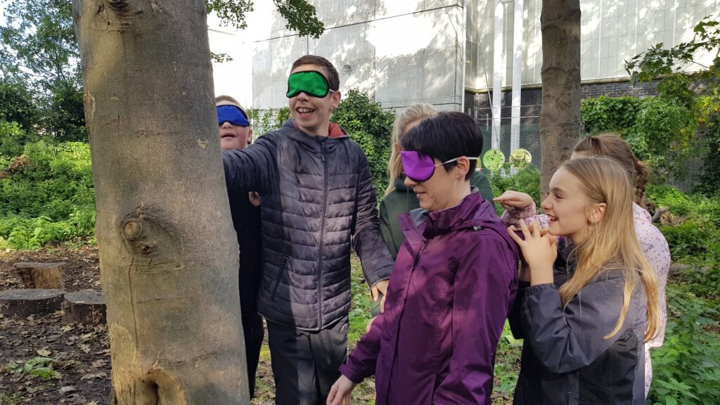 kids doing fun learning exercises with a tree outside
