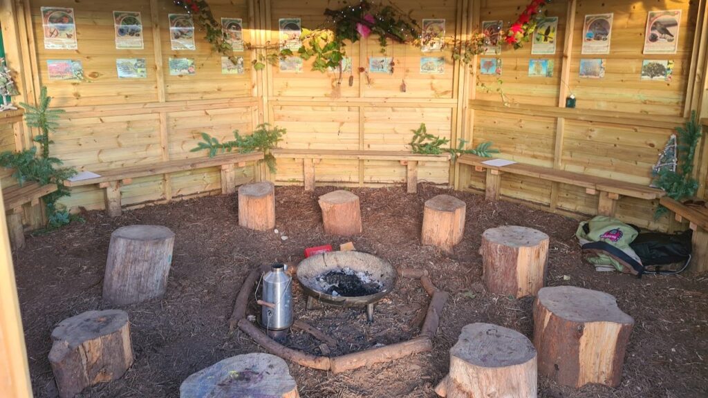 an open-air wooden hut designed as a classroom