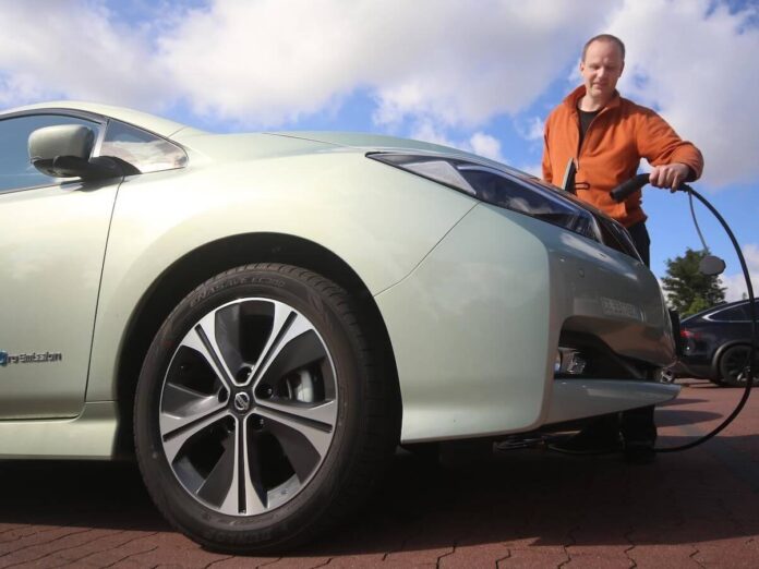 a man charging his car